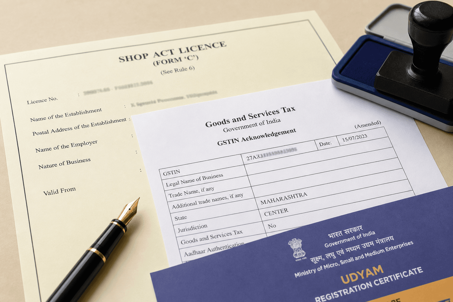 Compliance paperwork including Shop Act, GST and Udyam documents with fountain pen